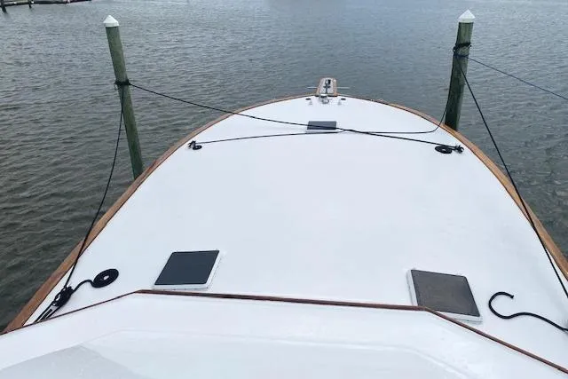Slide: The Image of Bow view of 1989 Buddy Davis 61 Sportfish yacht docked at marina. - 42