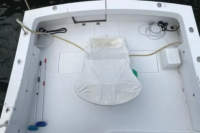 Slide: The Image of 1989 Buddy Davis 61 Sportfish boat deck with fishing chair and equipment. - 43