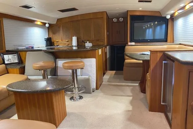 Slide: The Image of Interior of a 1989 Buddy Davis 61 Sportfish yacht with modern furnishings and wood accents. - 6
