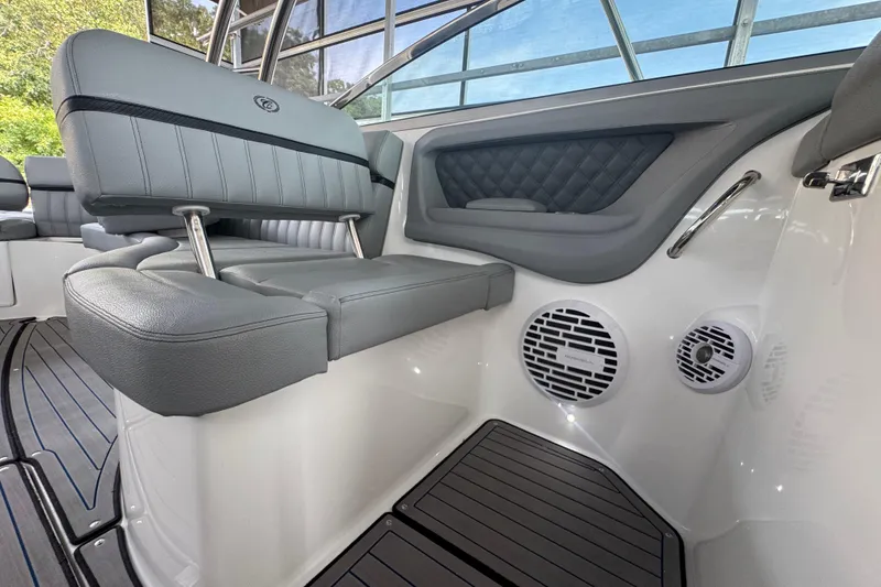 Slide: The Image of 2022 Cobalt R35 boat interior with gray seating and built-in speakers. - 11
