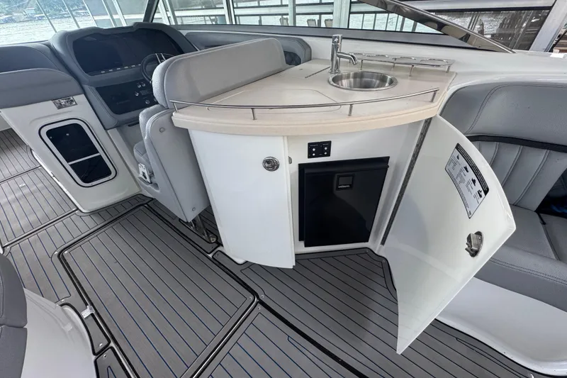 Slide: The Image of 2022 Cobalt R35 boat interior with kitchenette, sink, and seating area. - 14