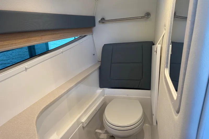 Slide: The Image of 2022 Cobalt R35 boat interior bathroom with toilet and window view. - 20