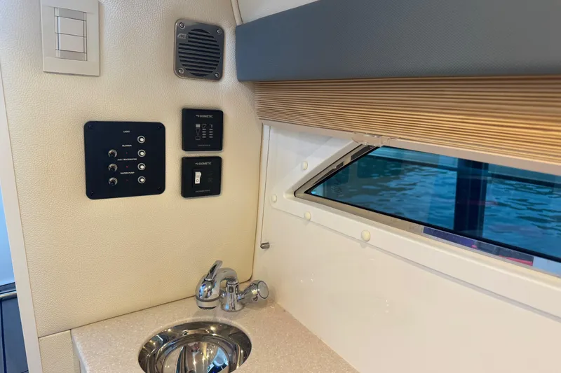 Slide: The Image of Interior of 2022 Cobalt R35 boat with sink, controls, and window view. - 21