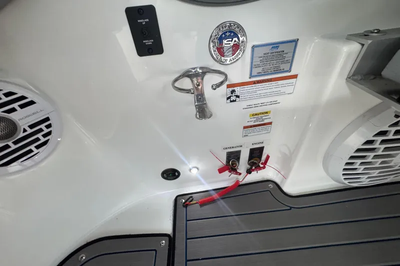 Slide: The Image of 2022 Cobalt R35 boat interior with controls, speakers, and safety labels. - 26
