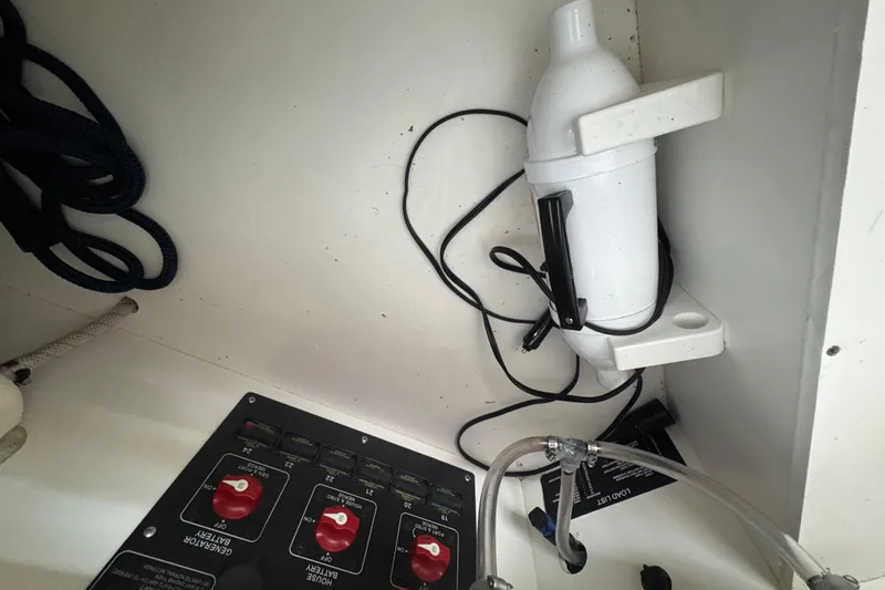 Slide: The Image of Electrical panel and equipment inside a 2022 Cobalt R35 boat compartment. - 27