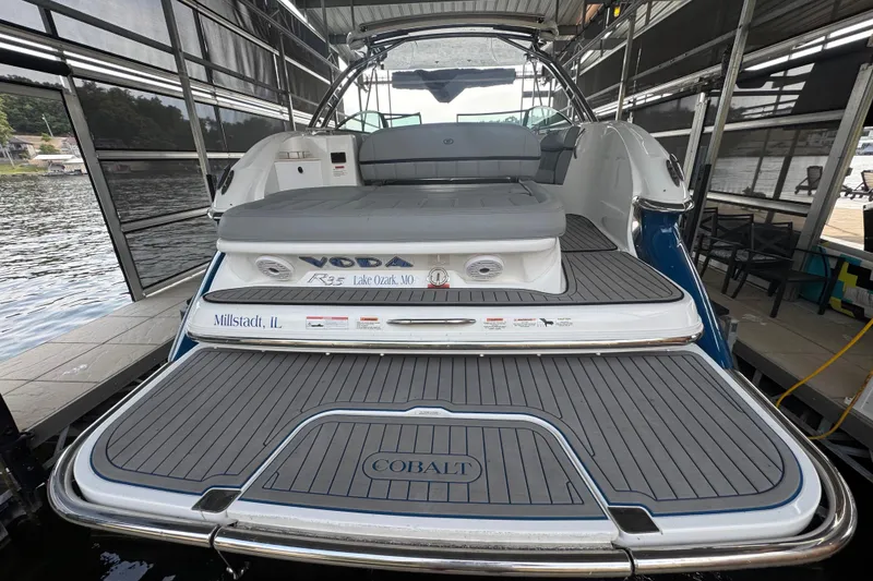 Slide: The Image of 2022 Cobalt R35 boat docked, featuring spacious deck and seating area. - 3