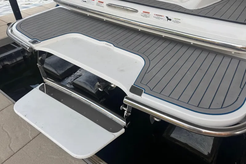 Slide: The Image of 2022 Cobalt R35 boat swim platform with gray decking and stainless steel railing. - 4