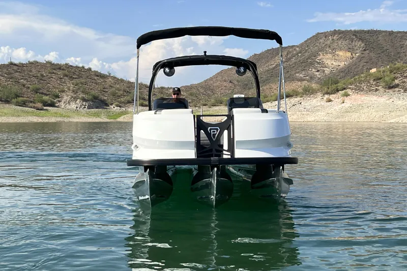 Slide: The Image of 2026 Paradigm Boats 27SST on serene lake with mountainous backdrop. - 17