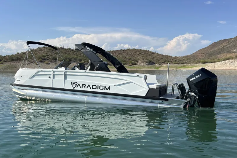 Slide: The Image of 2026 Paradigm Boats 27SST on serene lake, showcasing sleek design and powerful Mercury engine. - 3