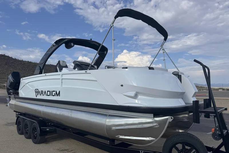 Slide: The Image of 2026 Paradigm Boats 27SST on trailer, sleek design under a cloudy sky. - 4