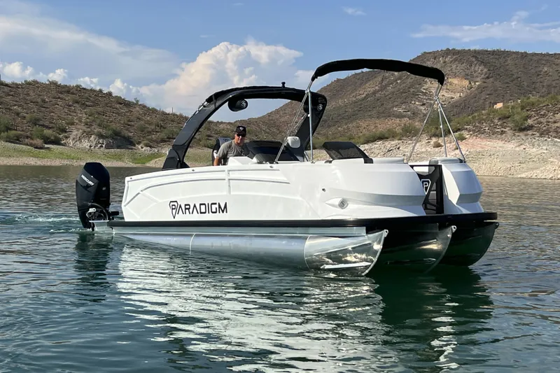 Slide: The Image of 2026 Paradigm Boats 27SST on a serene lake, showcasing sleek design and modern features. - 8