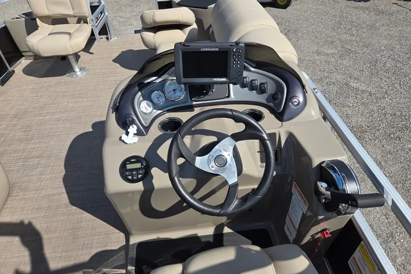 Slide: The Image of 2021 Sun Tracker Fishin' Barge 20 DLX dashboard with steering wheel and navigation system. - 11