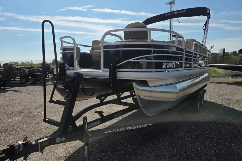 Slide: The Image of 2021 Sun Tracker Fishin' Barge 20 DLX pontoon boat on trailer, parked outdoors. - 3