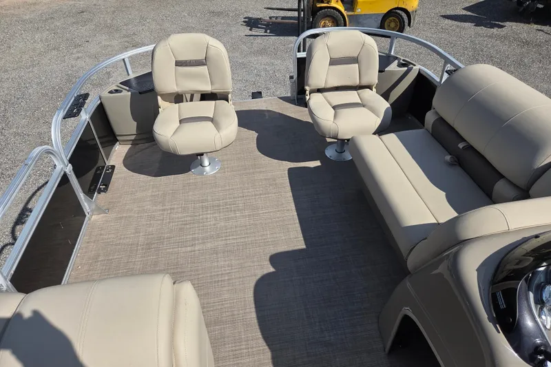 Slide: The Image of 2021 Sun Tracker Fishin' Barge 20 DLX interior with beige seating and spacious deck. - 9