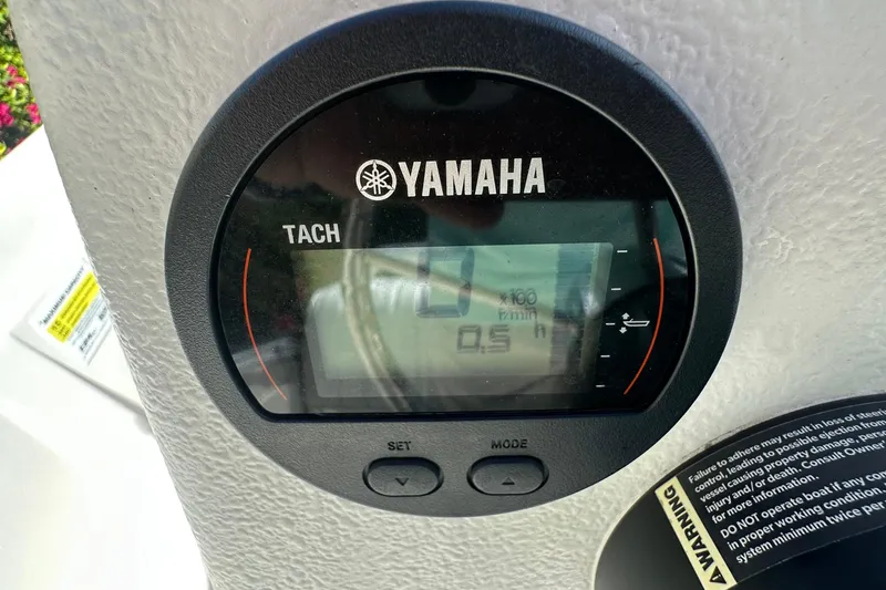 Slide: The Image of Yamaha tachometer on 2024 Carolina Skiff E24 DLX CC boat dashboard. - 11
