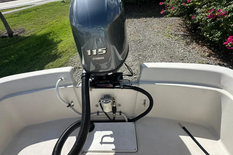 Slide: The Image of 2024 Carolina Skiff E24 DLX CC with Yamaha 115 engine, outdoor setting. - 6