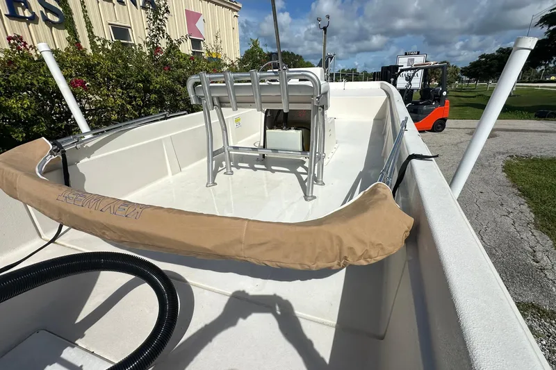 Slide: The Image of 2024 Carolina Skiff E24 DLX CC boat interior with seating and equipment, outdoor setting. - 7