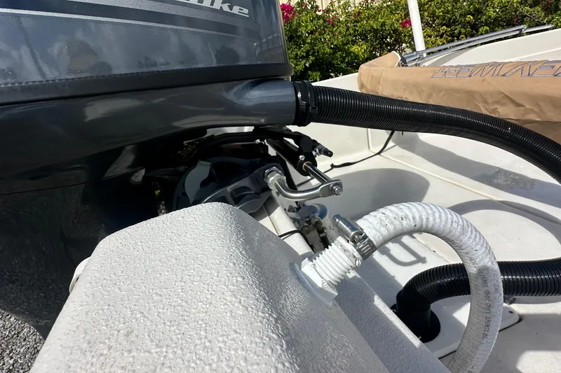 Slide: The Image of 2024 Carolina Skiff E24 DLX CC boat engine and hose details. - 8