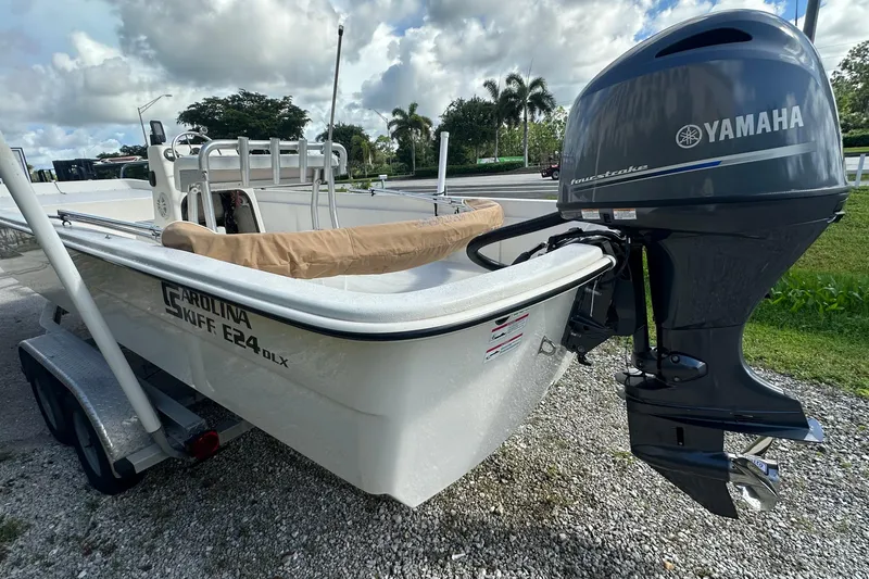 Slide: The Image of 2024 Carolina Skiff E24 DLX CC boat with Yamaha outboard motor on trailer. - 9