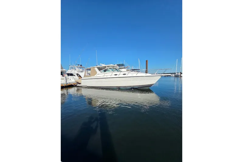 Slide: The Image of 1999 Tiara Yachts 4000 Express docked in a marina under clear blue skies. - 11