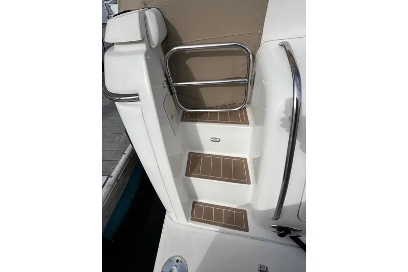 Slide: The Image of Steps on a 1999 Tiara Yachts 4000 Express, featuring stainless steel railings. - 13