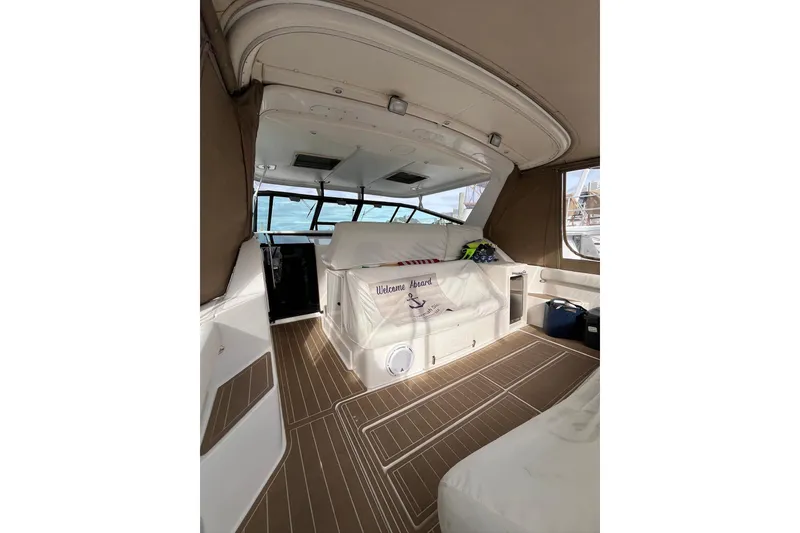 Slide: The Image of 1999 Tiara Yachts 4000 Express interior with seating and nautical decor. - 15