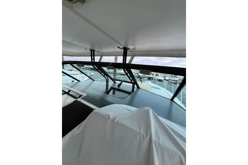 Slide: The Image of 1999 Tiara Yachts 4000 Express interior view with marina backdrop. - 19