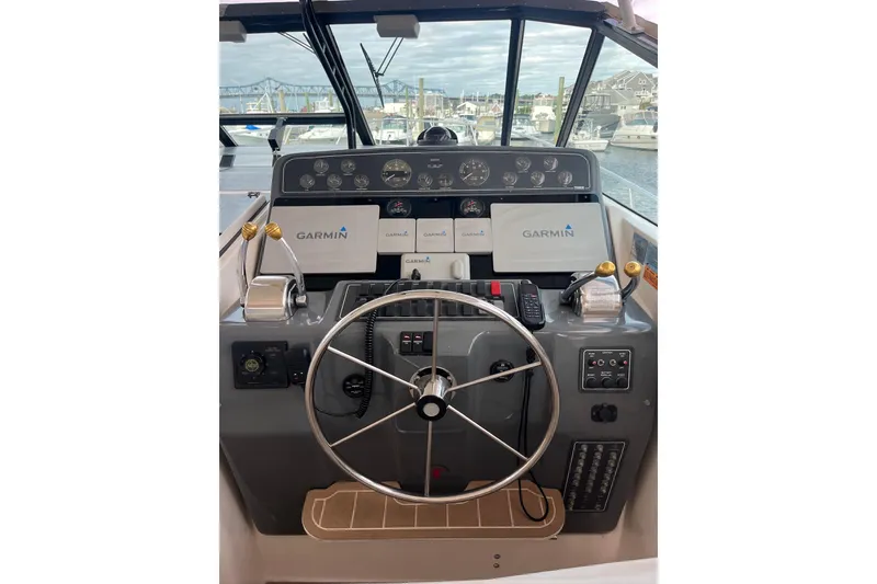 Slide: The Image of 1999 Tiara Yachts 4000 Express helm with Garmin navigation, docked in marina. - 21