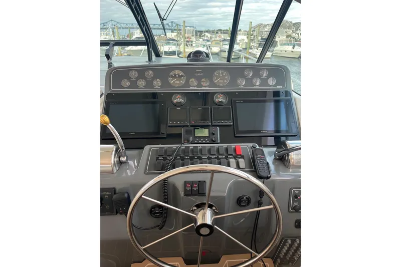 Slide: The Image of 1999 Tiara Yachts 4000 Express helm with modern navigation equipment and controls. - 22