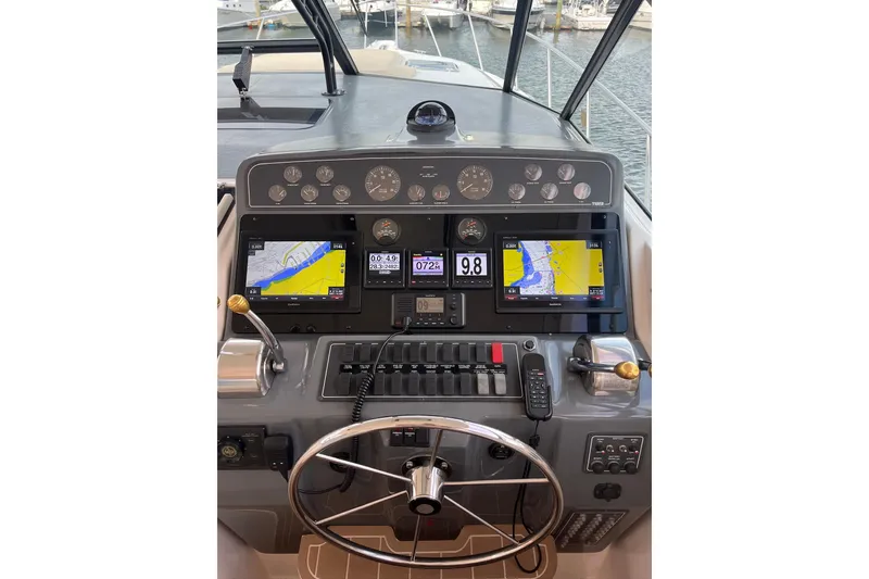 Slide: The Image of 1999 Tiara Yachts 4000 Express dashboard with navigation screens and controls. - 23