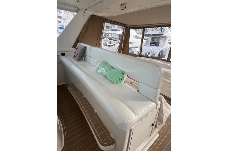 Slide: The Image of 1999 Tiara Yachts 4000 Express interior with white seating and nautical decor. - 24