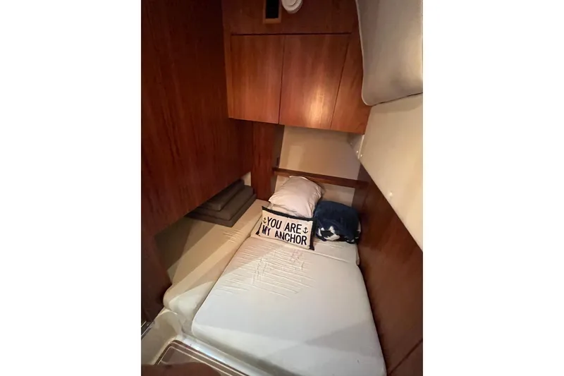 Slide: The Image of 1999 Tiara Yachts 4000 Express cabin with cozy bed and nautical-themed pillow. - 35