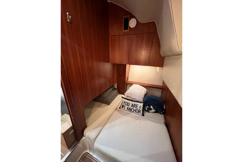 Slide: The Image of 1999 Tiara Yachts 4000 Express cabin with cozy bed and nautical decor. - 36