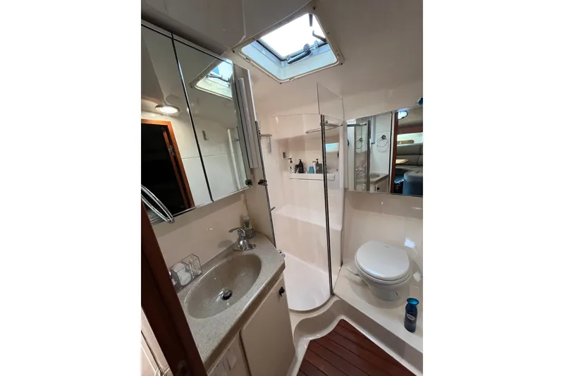 Slide: The Image of Bathroom interior of 1999 Tiara Yachts 4000 Express, featuring sink, toilet, and shower. - 37