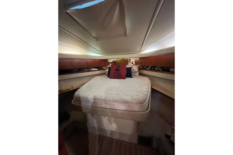Slide: The Image of 1999 Tiara Yachts 4000 Express cabin interior with bed and wooden accents. - 39