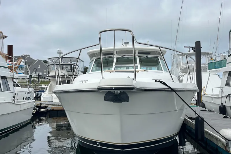 Slide: The Image of 1999 Tiara Yachts 4000 Express docked at marina, front view. - 4