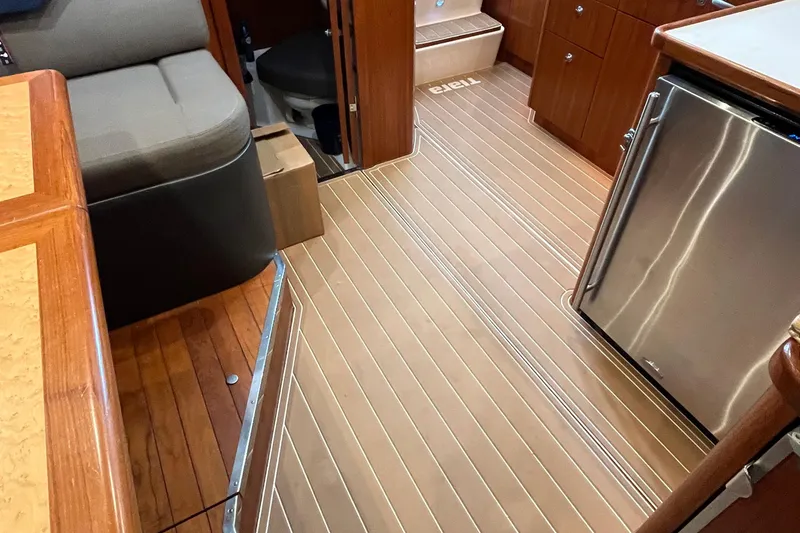 Slide: The Image of Interior of 1999 Tiara Yachts 4000 Express with wood flooring and modern amenities. - 43