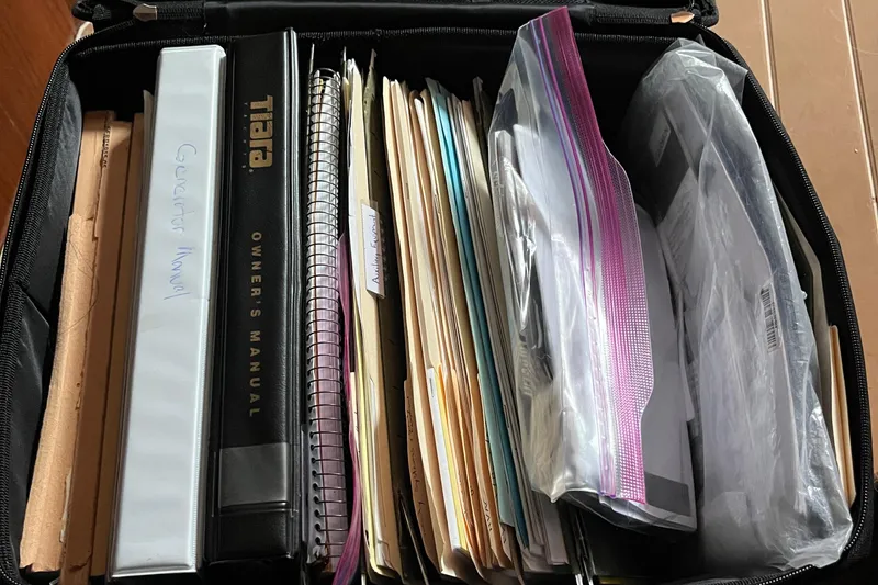 Slide: The Image of Collection of manuals and documents for 1999 Tiara Yachts 4000 Express in a case. - 46