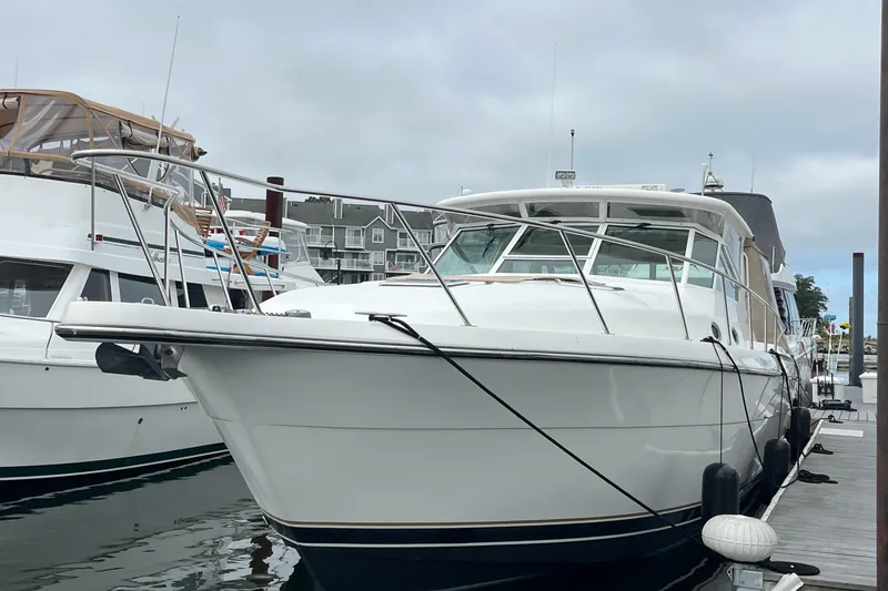Slide: The Image of 1999 Tiara Yachts 4000 Express docked at marina, overcast sky. - 5