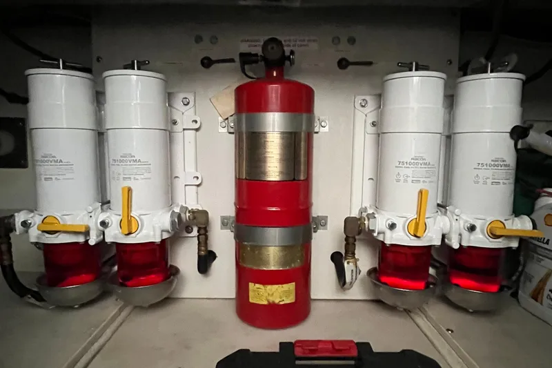 Slide: The Image of Engine room of 1999 Tiara Yachts 4000 Express with fuel filters and fire extinguisher. - 52