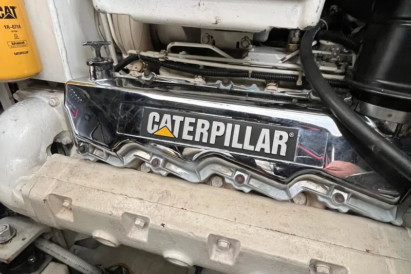Slide: The Image of Caterpillar engine in a 1999 Tiara Yachts 4000 Express, showcasing chrome details. - 55