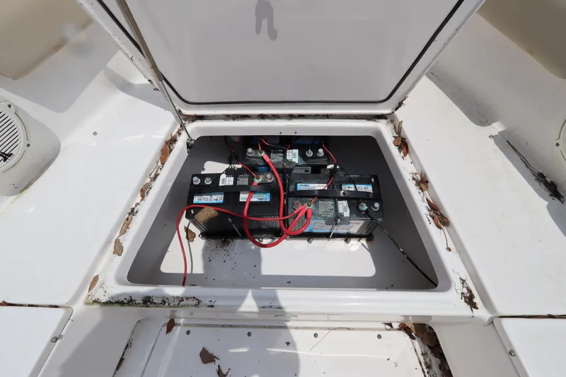 Slide: The Image of Open battery compartment of 2020 Everglades 243 Center Console boat, showing multiple batteries. - 12