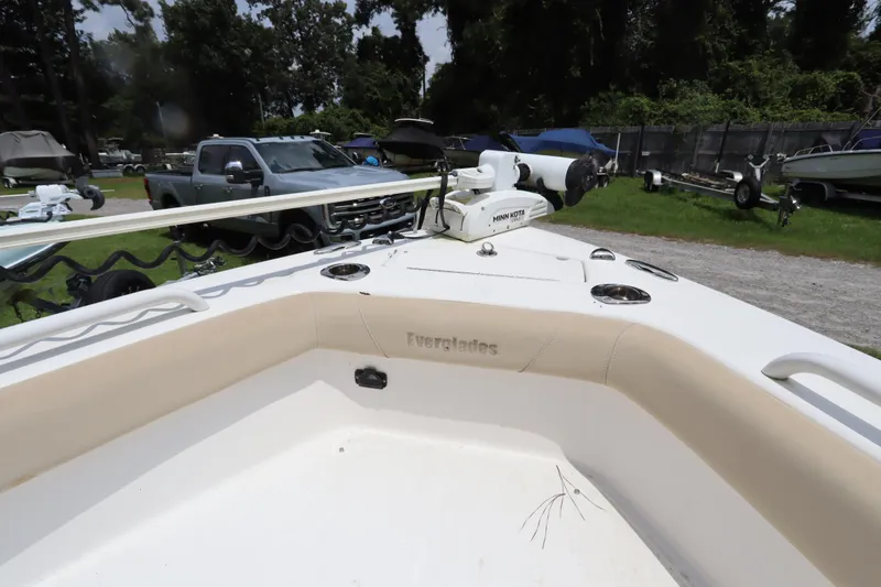Slide: The Image of 2020 Everglades 243 Center Console boat with Minn Kota trolling motor, parked outdoors. - 13