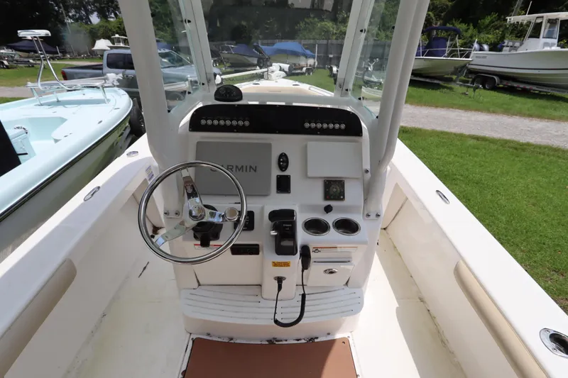 Slide: The Image of 2020 Everglades 243 Center Console boat interior with steering wheel and control panel. - 17