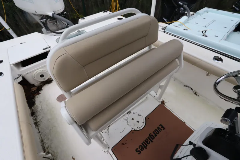Slide: The Image of 2020 Everglades 243 Center Console boat interior with beige seating and steering wheel. - 20