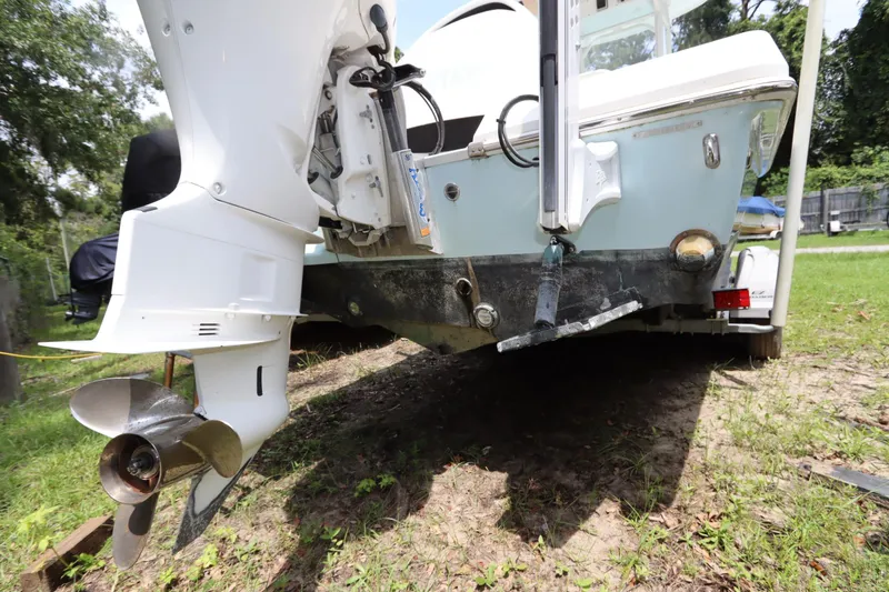 Slide: The Image of 2020 Everglades 243 Center Console boat with outboard motor on grassy area. - 25