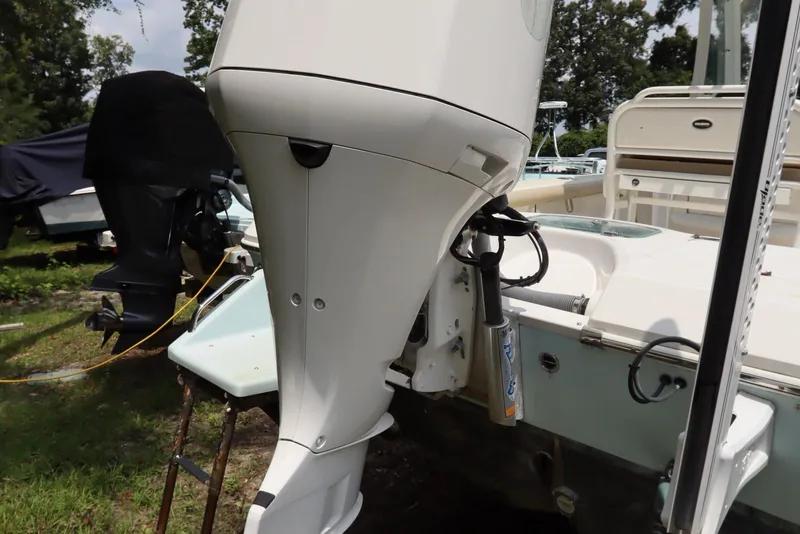 Slide: The Image of 2020 Everglades 243 Center Console boat with outboard motor, parked outdoors. - 6