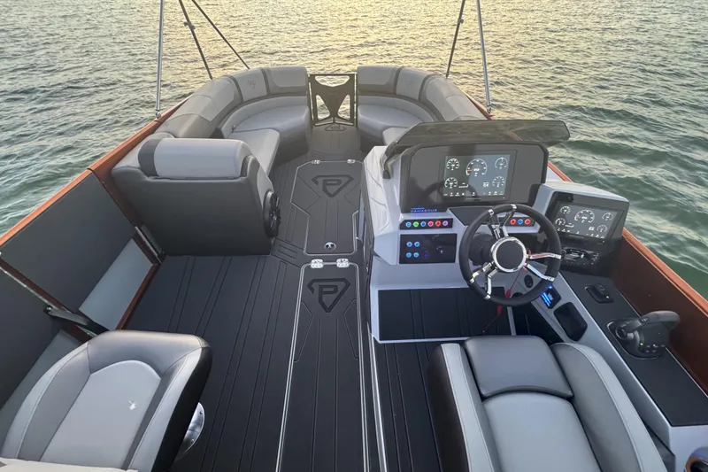 Slide: The Image of 2026 Paradigm 236 Surf boat interior with modern dashboard and seating on water. - 12