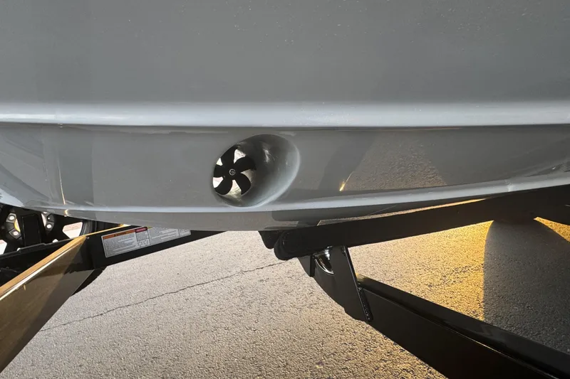 Slide: The Image of 2026 Paradigm 236 Surf boat hull with propeller detail, on a trailer. - 13