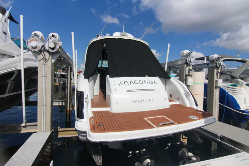 Slide: The Image of 2008 Formula 400 Super Sport yacht docked, featuring teak deck and covered cockpit. - 1